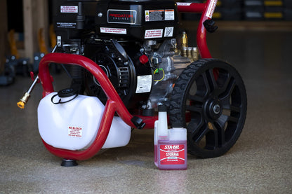 Pressure washer with a bottle of Stabia oil on a concrete floor